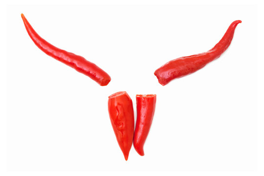 Chili peppers in devil's shape. Red chili peppers isolated on white background. Old Nick shape created with red chili peppers.