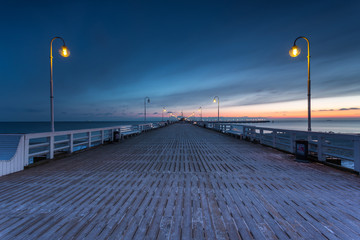 Cold winter morning, Pier in Sopot at sunrise time with amazing colorful sky. Poland.
