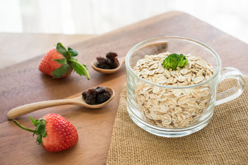 Fresh breakfast of healthy oatmeal in glass with strawberries on