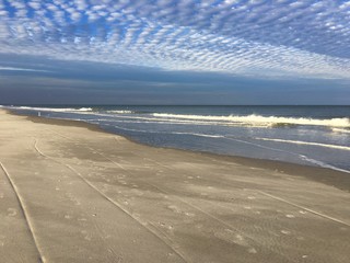 Cirrocumulus clouds form a herringbone or mackerel sky over the ocean at Jacksonville Beach, Florida, USA. 