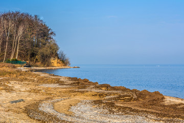 Fototapeta na wymiar Shoreline with small cliff in Oslonino village at the shore of Baltic Sea. Poland.