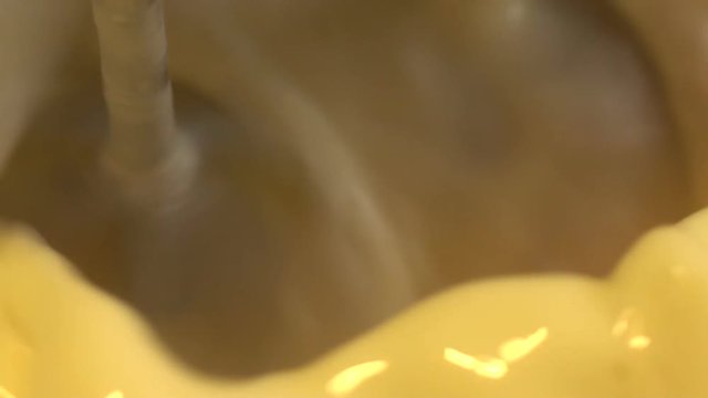 mixer whips egg whites in slow motion close up