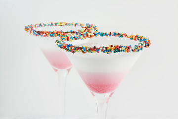 White milk shake cocktail, close-up. Decorated with jelly hearts and sprinkles.