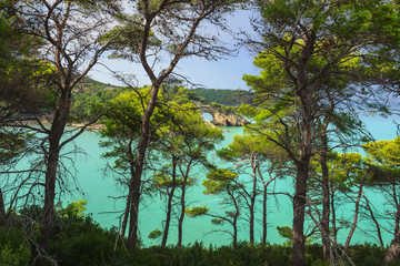 Apulia coast: San Felice Bay is located in the Gargano National Park.The little rock arch (called...