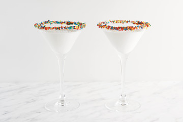 White milk shake cocktail, close-up. Decorated with jelly hearts and sprinkles.