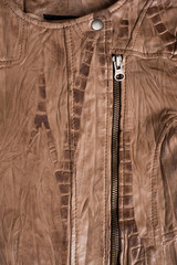 Brown textured leather jacket. Leather jacket macro details. Jacket zippers and pockets.