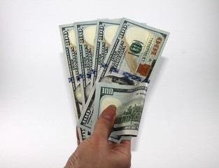 female hand holds hundred dollars