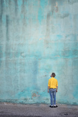 Man looking at the blue wall 