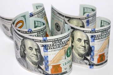 Rolled hundred us dollars banknote