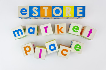 eSTORE marketplace concept spelled out with toy blocks. Isolated.