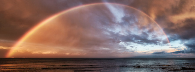 Panoramic view of rainbow over the ocean