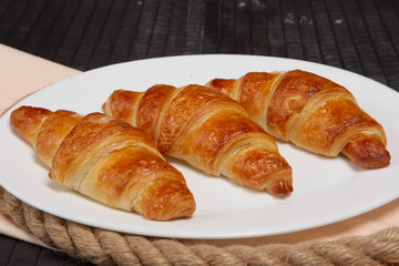 Fresh baked croissants on plate