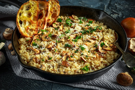 Mushroom Risotto in iron pan with herbs and parmesan cheese