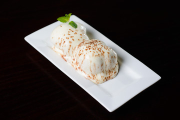Cream puff or profiterole with filling, powdered sugar topping