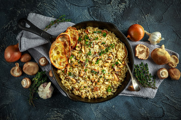 Mushroom Risotto in iron pan with herbs and parmesan cheese