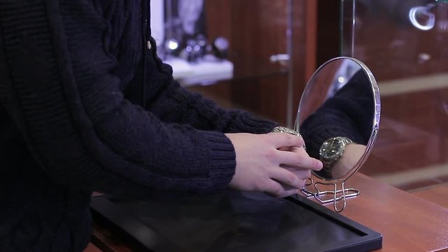 Young Man trying watch in the store