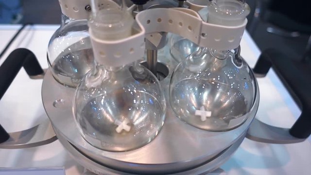Laboratory magnetic mixer at the same time for five flasks demonstrates its capabilities without solution. Shot in motion
