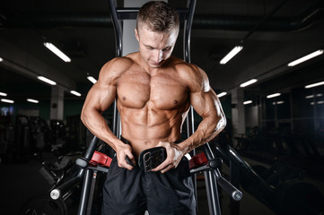 Handsome fitness model train in the gym gain muscle