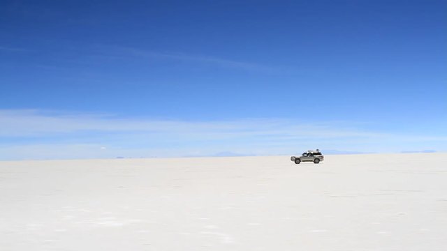 SUV driving on the Salar de Uyuni, Bolivia