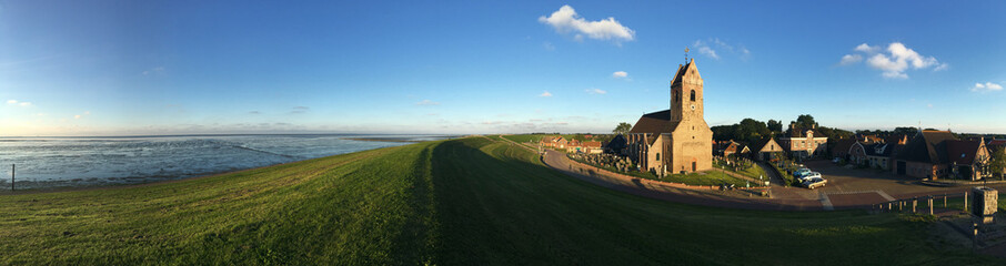Naklejka premium Panorama from the dyke and church