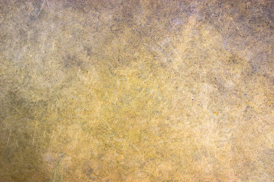 Bronze metal background closeup, matte texture with a golden hue