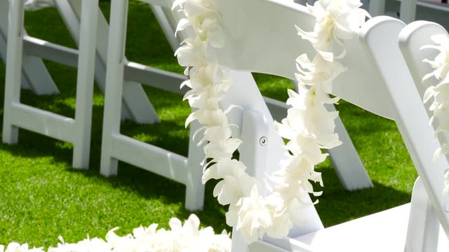 Hawaiian white lei for wedding guests on the chair