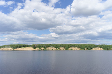 View of the high bank of the river with sandy precipices forested, Volga, Russia