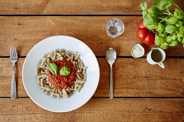 a plate of pasta with tomato sauce in hip restaurant