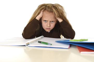  little schoolgirl sad and tired looking depressed suffering stress overwhelmed by load of homework