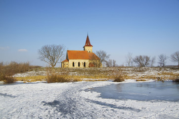 Abandoned church of St. Linhart on frozen Musov reservoir