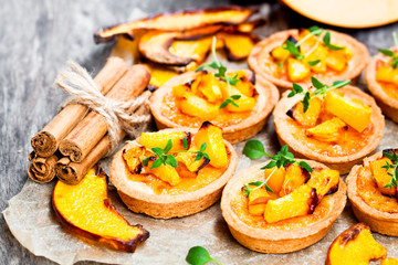 delicious  tartlets with baked honey pumpkin and cinnamon on rus