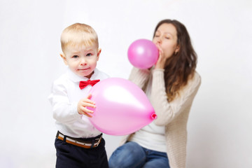 People, childhood, children, holidays concept - Cropped shot of mother and her son playing with red  balloons.