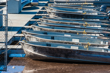 Fototapeta na wymiar Bows of motorboats lined up along Lake Casitas dock.
