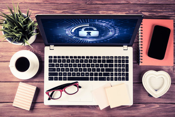 Web security and technology concept with laptop on wooden table