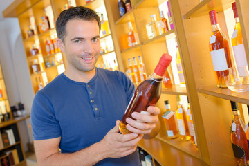 handsome young man choosing fine wines