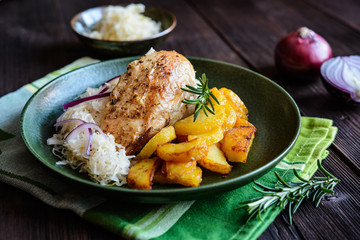 Roasted chicken breast with potato, steamed sour cabbage and onion              