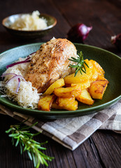 Roasted chicken breast with potato, steamed sour cabbage and onion              