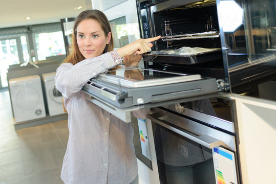 woman looking at ove in home appliance store