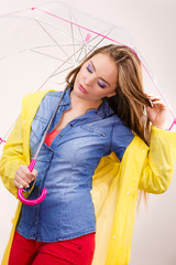 Woman wearing waterproof coat holding umbrella