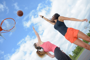 Fototapeta na wymiar Women playing basketball outdoors