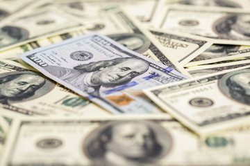  cash money close up. one new and pile of old hundred dollar bil