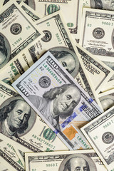  cash money close up. one new and pile of old hundred dollar bil