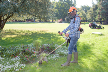 using a handheld mower