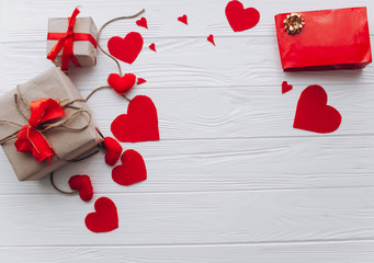 Valentine's Day. presents, heart felt and decor on wooden background