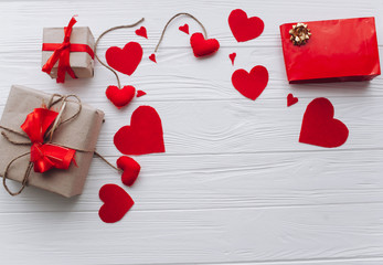 Valentine's Day. presents, heart felt and decor on wooden background