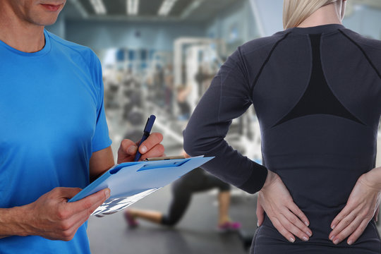 Sport Woman with Back Pain in Gym . Sports exercising injury. Rehabilitation and Exercise for Healthy Back