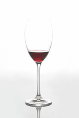glass with red wine on a light background