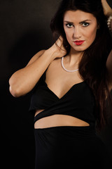 Fototapeta premium woman in sensual black dress on dark