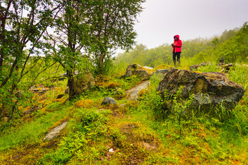Obraz premium Tourist taking photo in mountains Norway