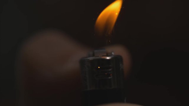 Front shot of lighter lighting macro slow motion